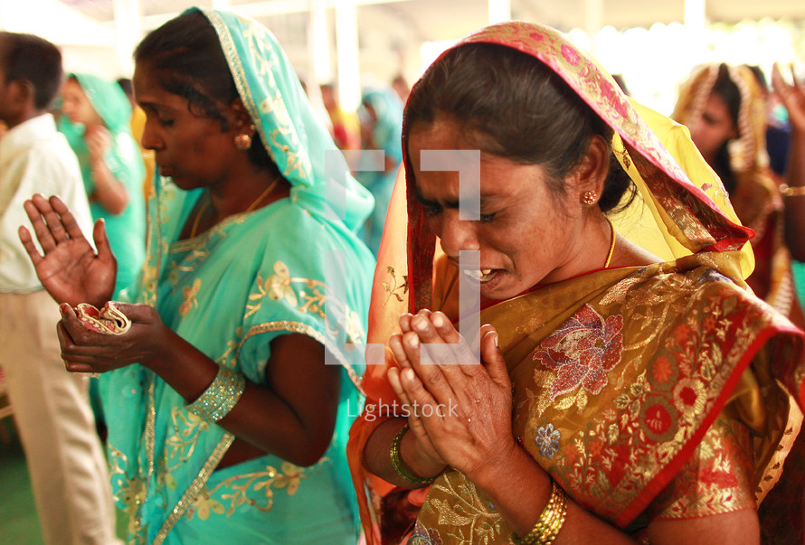 women in prayer in India