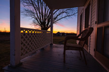Chair on a porch at sunrise