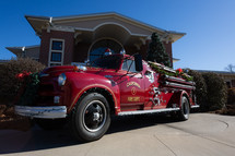 Refurbished vintage red fire truck decorated for Christmas