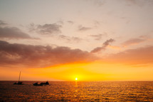boats on the water in Kona at sunset 
