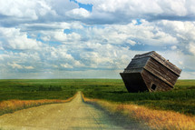 digital composition of a flipped home by a long country road