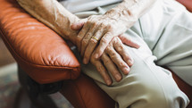 elderly man's hands in his lap 