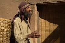 a man selling grains at the market in biblical times 