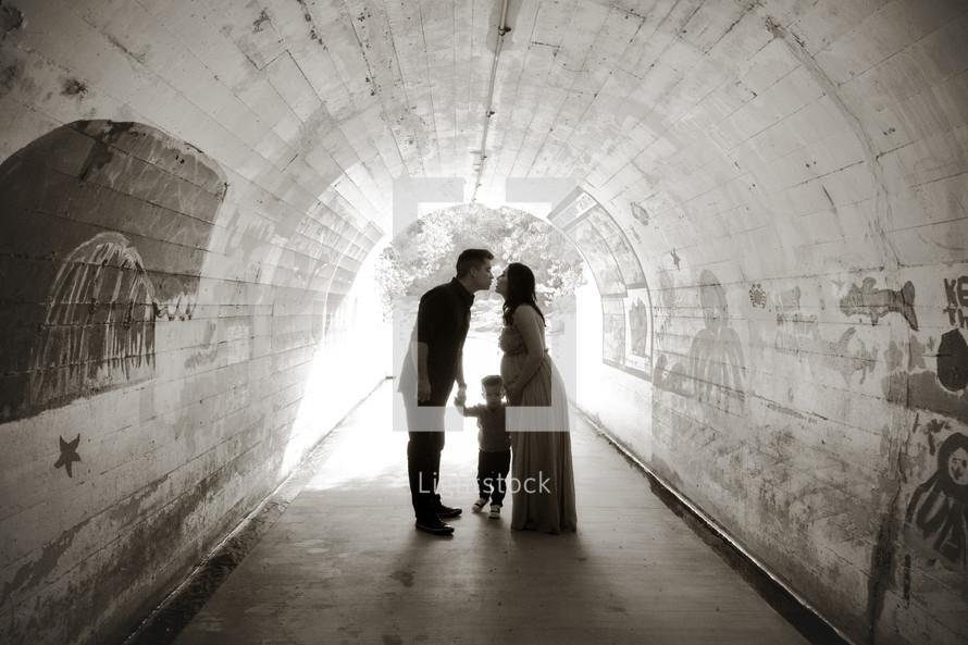 a young family standing in a tunnel 