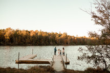 a family standing on a dock in fall 