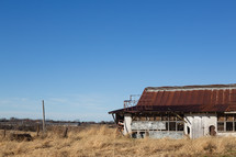 Wooden building with rusted roof in rural area