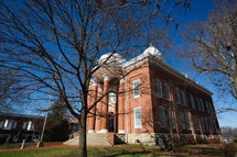 Red brick courthouse building with white dome