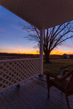 Chair on a porch at sunrise