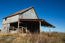 Wooden building with rust on the roof in rural area