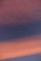 Crescent moon in sunrise clouds