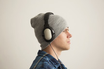 man with headphones and wool cap 