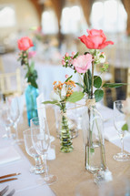 flowers in vases on a reception table 