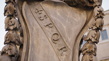 Spqr plate on a monument in the square of Rome 