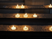 Candles lit by worshippers in a Christian church