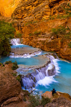 clear blue water in a river and red rock cliffs 