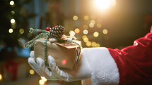 Santa Claus Hand Donate a Christmas Gift