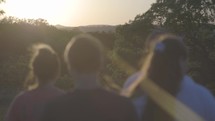 teens hiking outdoors at sunset 