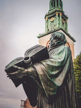 A statue of Martin Luther holding a bible