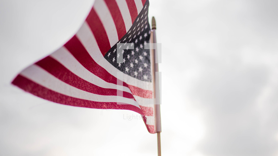American flag against an overcast sky 