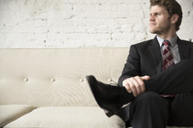 businessman sitting on a couch 