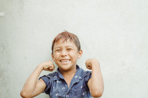 kid showing muscles 