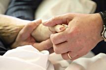 elderly couple holding hands 