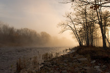 fog over a river at sunrise 