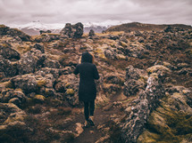 woman exploring a mountaintop landscape 