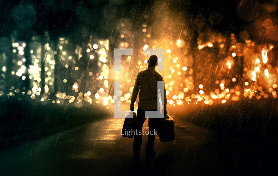 silhouette of a man holding luggage standing in front of a glowing forest 