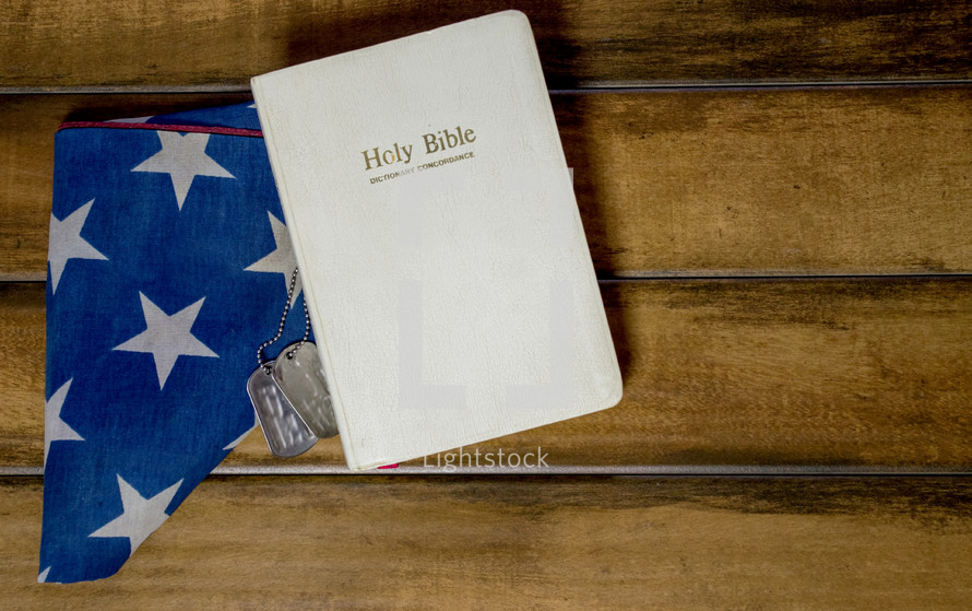 Holy Bible, folded American flag, and military dog tags
