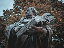 A statue of Martin Luther holding a bible