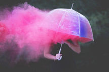 pink smoke and woman under an umbrella 