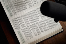 microphone over the pages of an opened Bible 