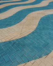 blue and white waves on brick pavers 