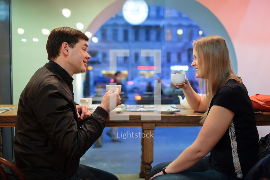 Man and woman chatting over coffee