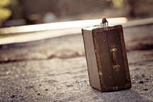 suitcase on a dirt road 