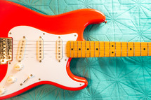 Fiesta Red Squire Stratocaster guitar on a blue background. São Paulo, Brazil, Juli 27, 2024.