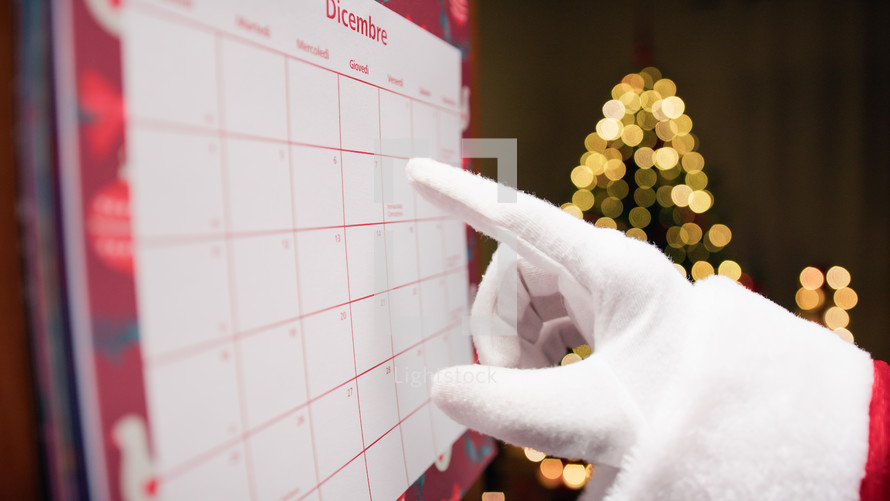 Santa Claus organizing his work with a calendar