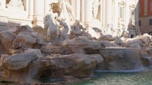Peaceful stream of water into Trevi Fountain