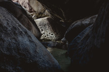 rocks and water in a cave 