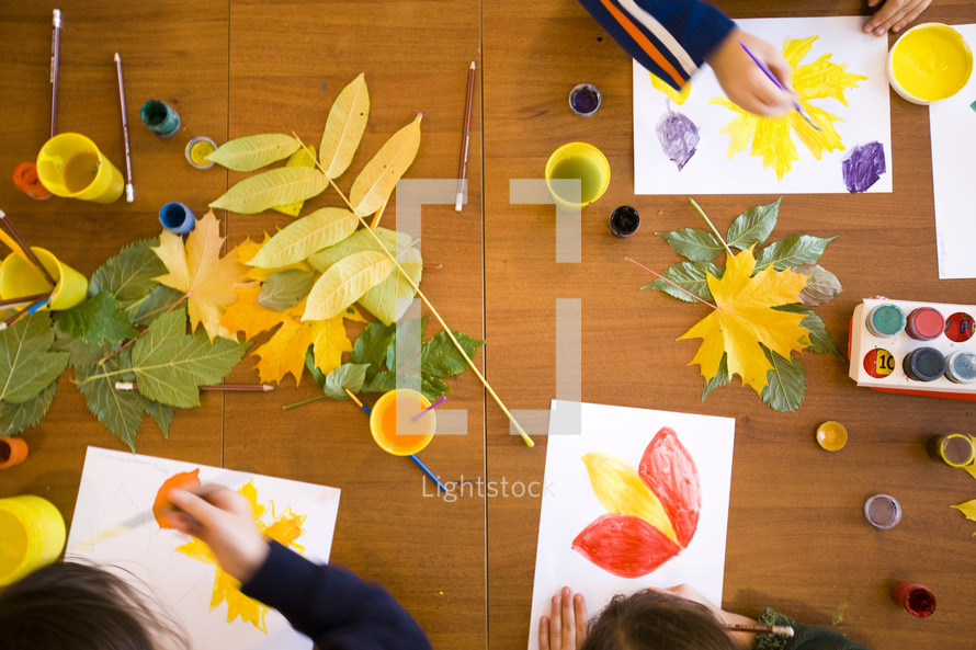 Kids draw and paint leaves in art class.