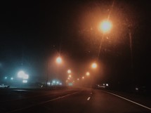 bokeh street lights through a windshield white driving at night 