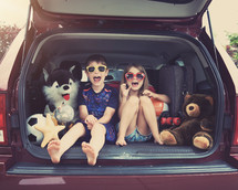 kids sitting in the back of an SUV