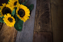 yellow sunflowers on wood boards