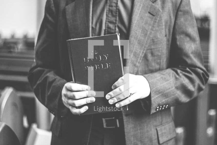 a man holding the Holy Bible 