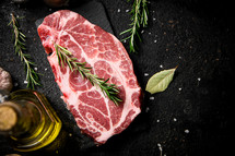 Raw pork steak on a stone board. On a black background. High quality photo