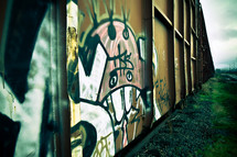 graffiti along the side of railroad box cars
