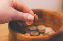 placing coins in a bowl 