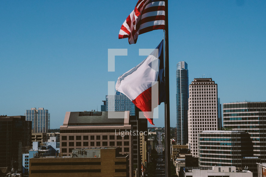 American flag and Texas flag on a flagpole 