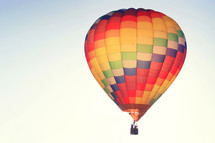 a colorful hot air balloon lifting up 